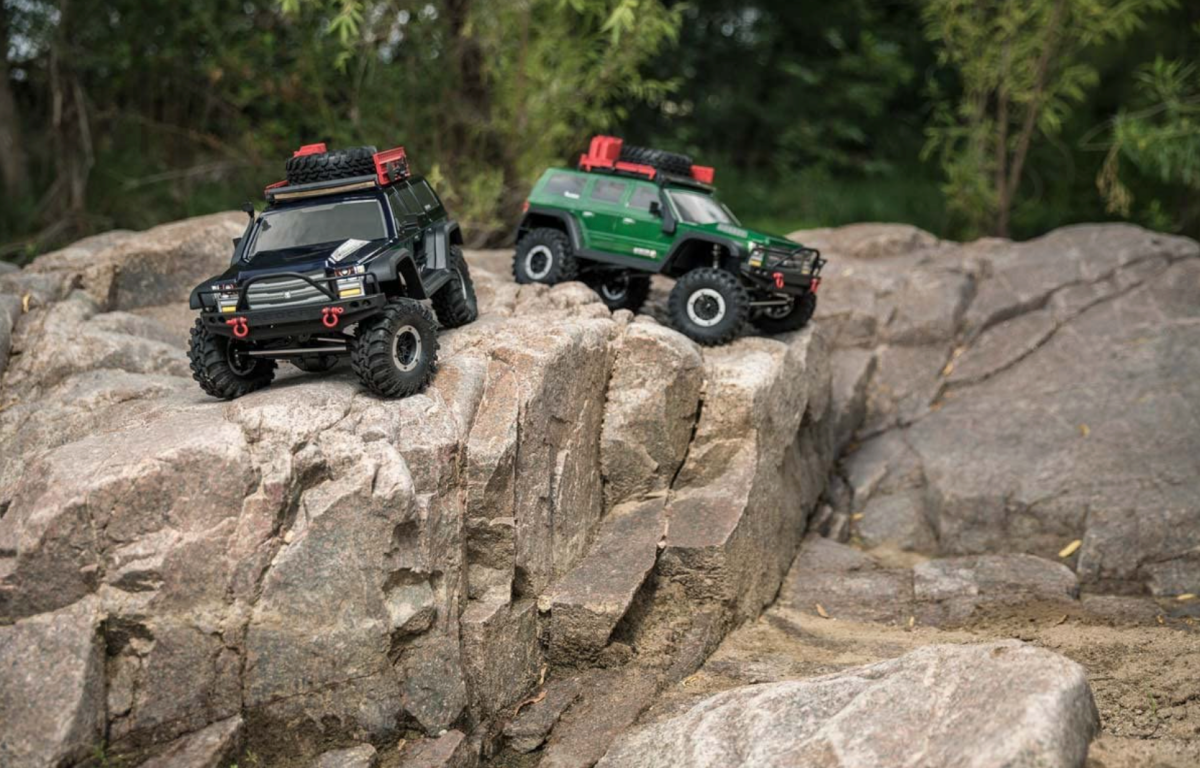 Two Redcat Racing Everest GEN7 Pro Rock Crawlers, one black and one green, in action