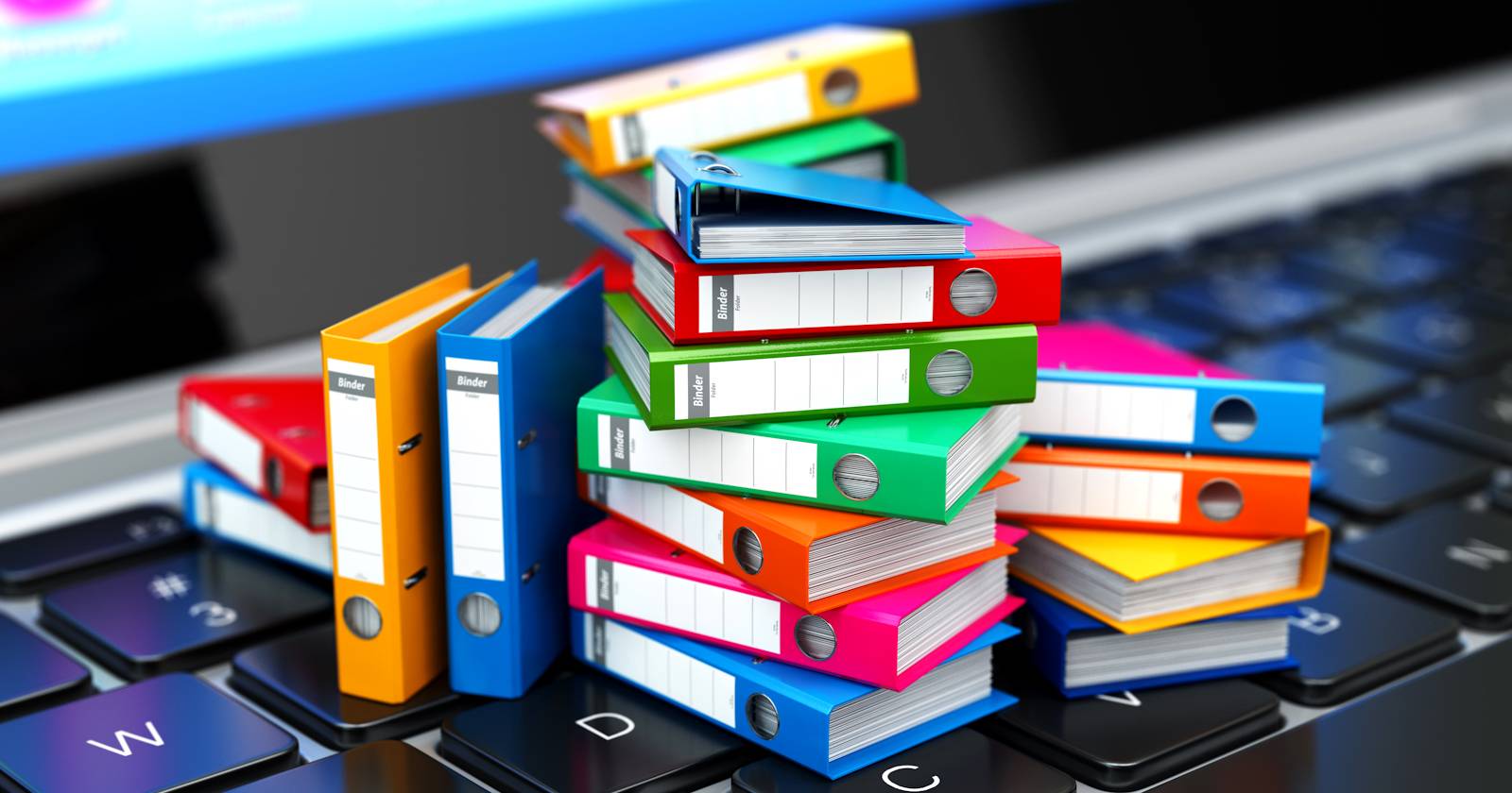 small file folders on top of a laptop keyboard feature