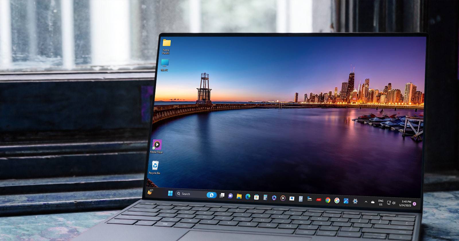 Windows 11 Laptop with a Desktop Wallpaper of a Scenic City