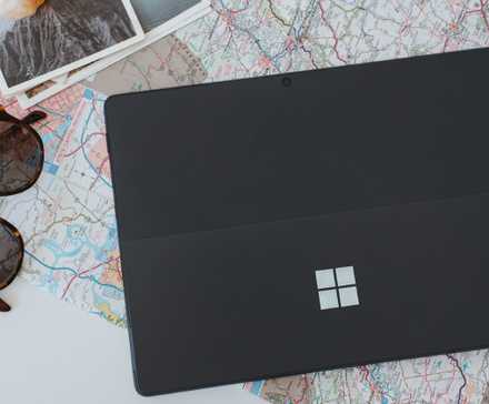 A black Windows laptop on a white table