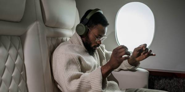 Person wearing headphones on a plane