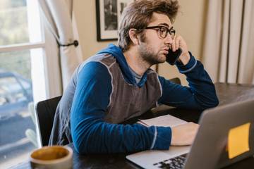 tired man works on laptop