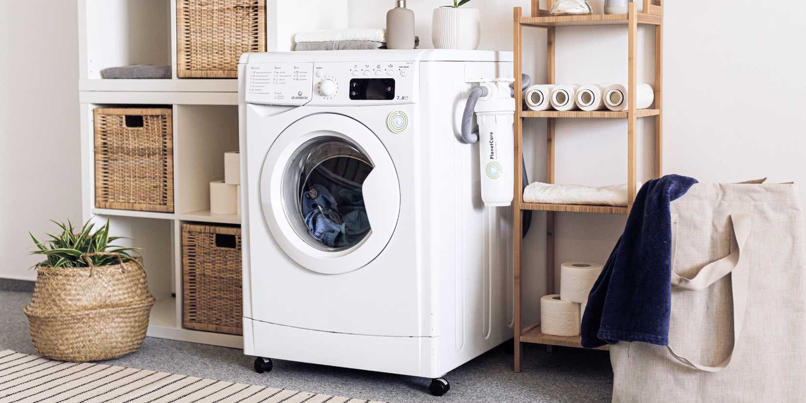 Washing machine next to shelves and laundry
