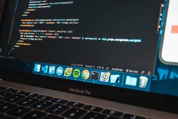 MacBook Pro laptop with program code on screen