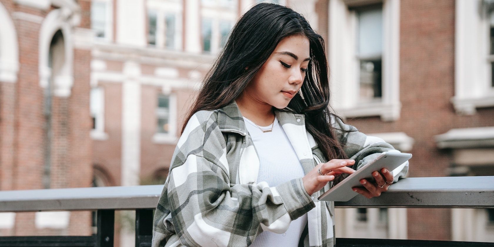 Lady scrolling on an iPad outside