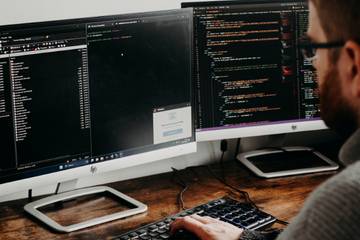 Man Working on Computers Coding