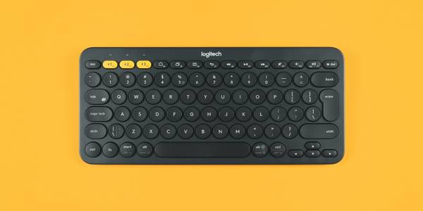 Black Logitech keyboard on yellow background