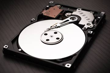 A computer hard disk on a black surface