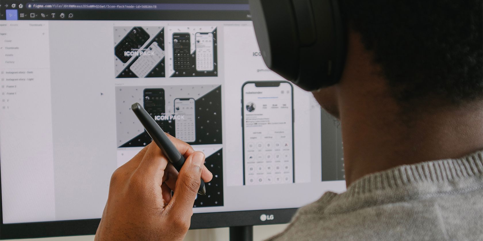 Man designing grayscale UX/UI design on computer.