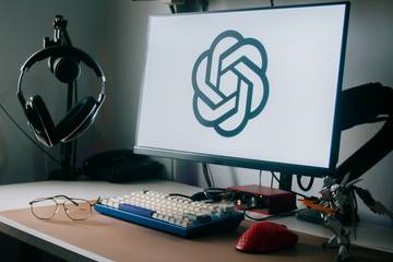 Monitor on a desk with OpenAI logo