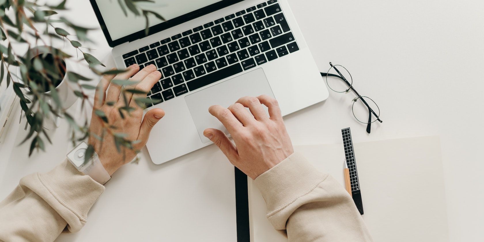 A Pair of Hands Working on a Computer