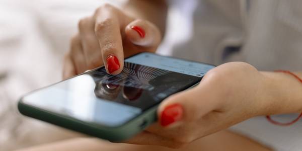 woman touching the screen of a phone