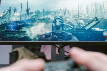 person playing fps game with controller