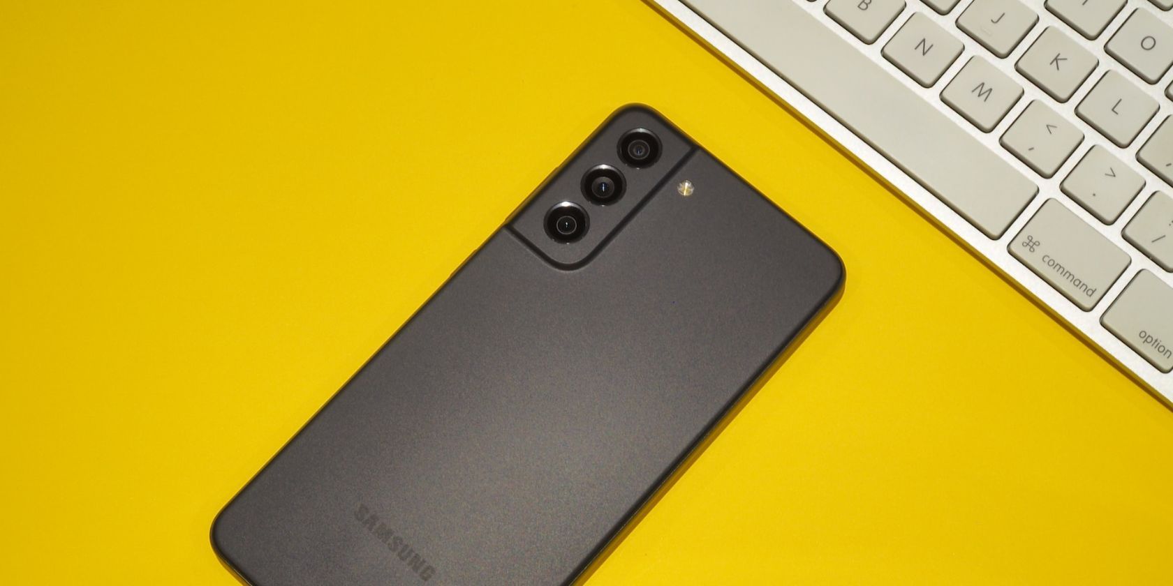 Samsung Galaxy phone besides a physical keyboard