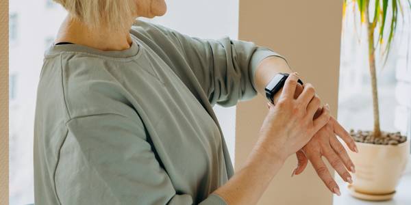 senior woman looking at smartwatch on wrist