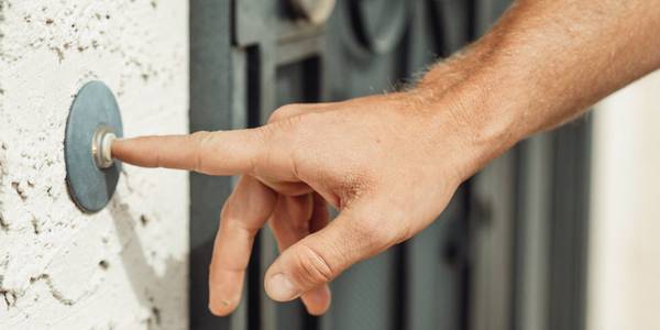 Doorbell being pushed by a finger