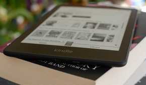 Kindle Paperwhite Signature Edition on a stack of books