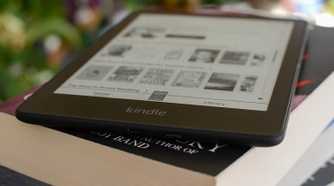 Kindle Paperwhite Signature Edition on a stack of books