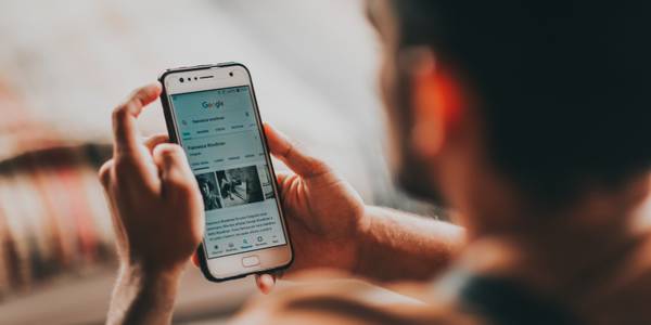 Man using android phone to browse the internet