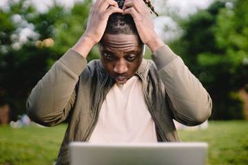 Frustrated man at laptop