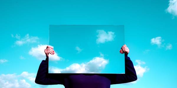 Man in black suit  standing behind the sky