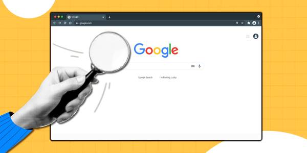 person holding magnifying glass over google chrome browser