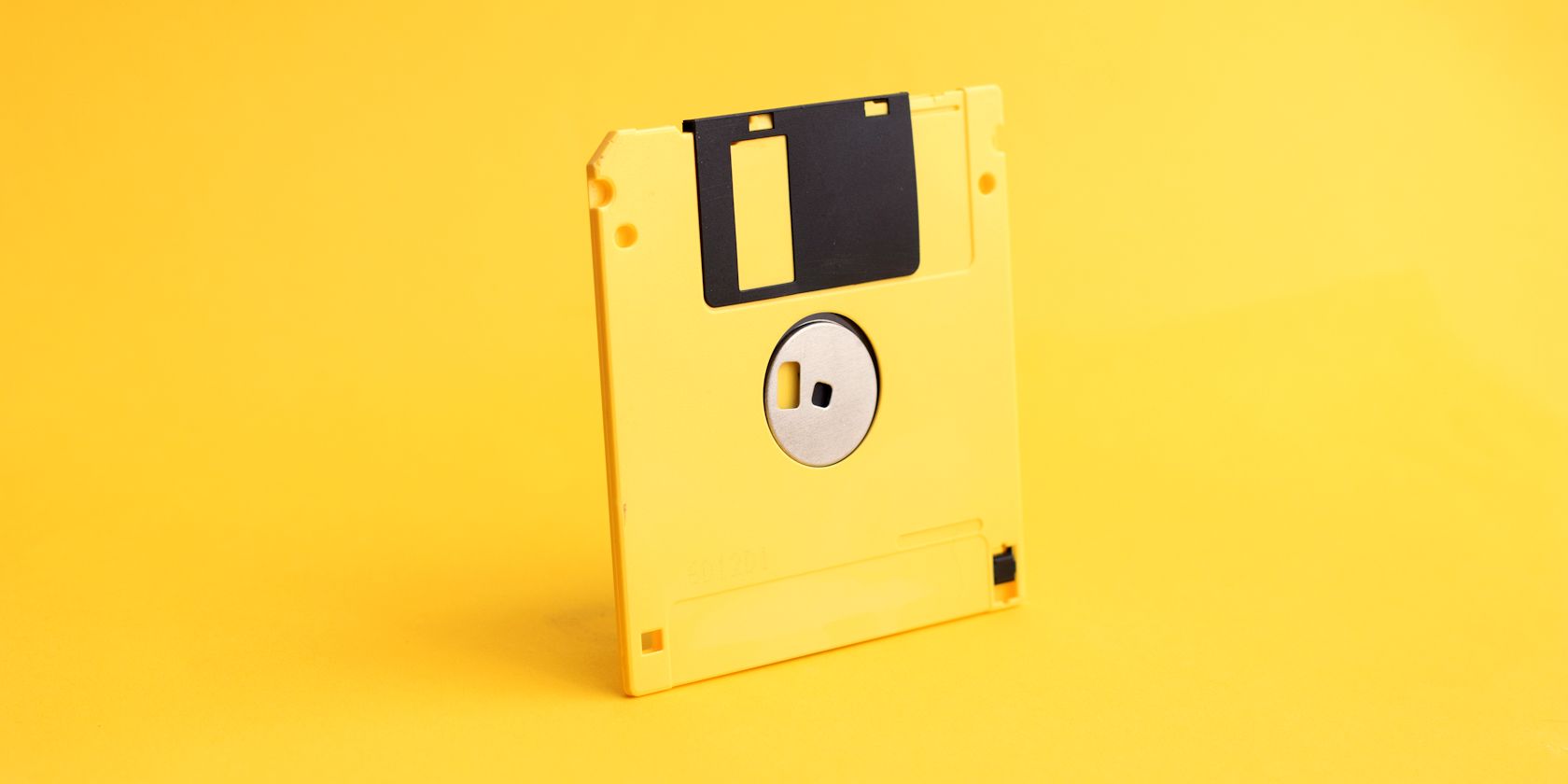 yellow floppy disk on yellow background