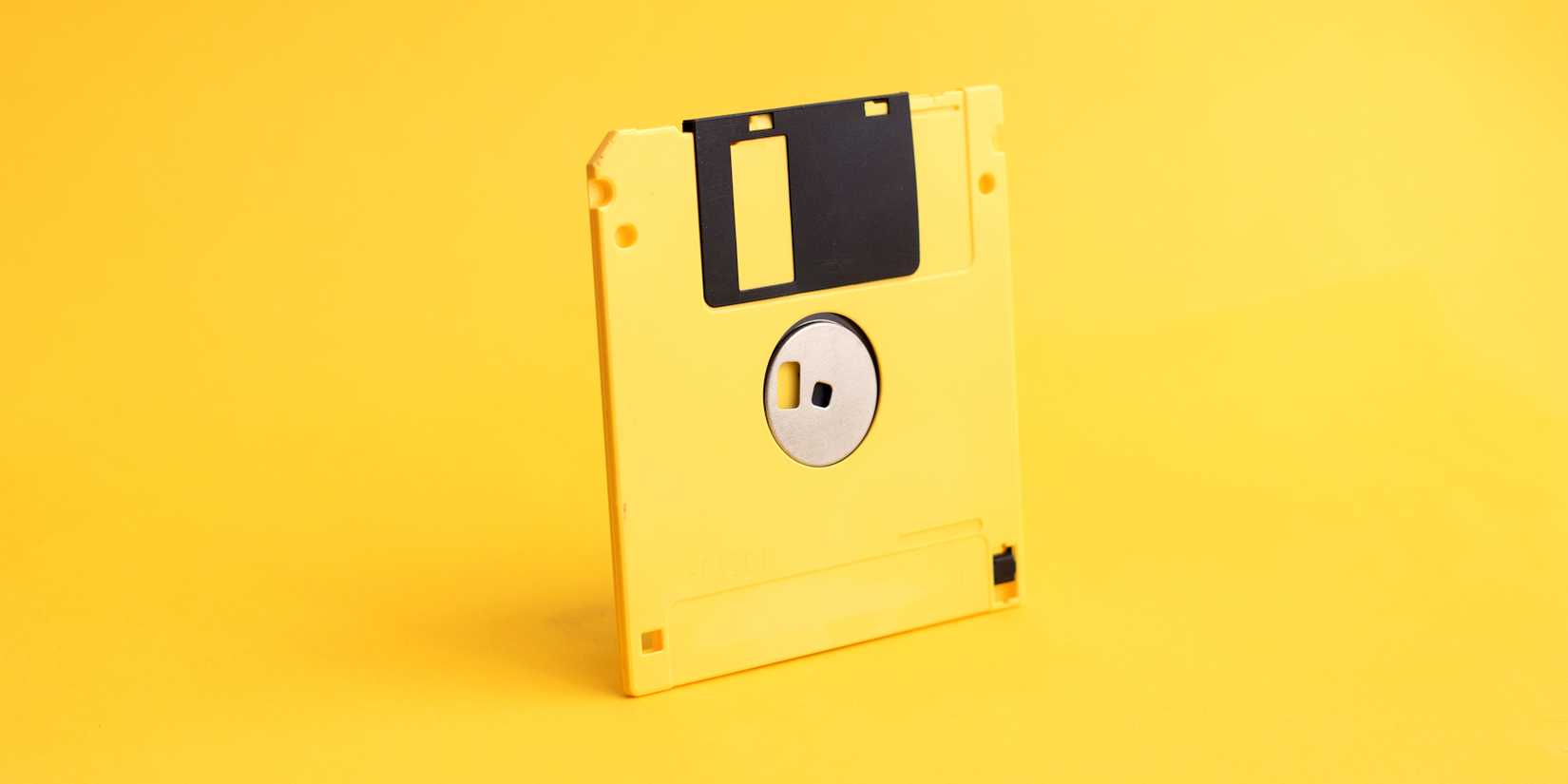 yellow floppy disk on yellow background