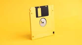 yellow floppy disk on yellow background