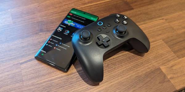 A Motorola Edge+ running Mantis Pro next to an 8BitDo Ultimate gamepad.