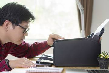 Man looking at printer on a desk