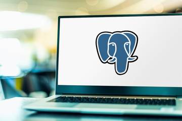 The PostgreSQL logo, a blue elephant head, displayed on a laptop screen