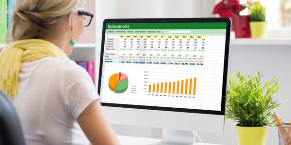 Woman working with data and graphs in Excel spreadsheet