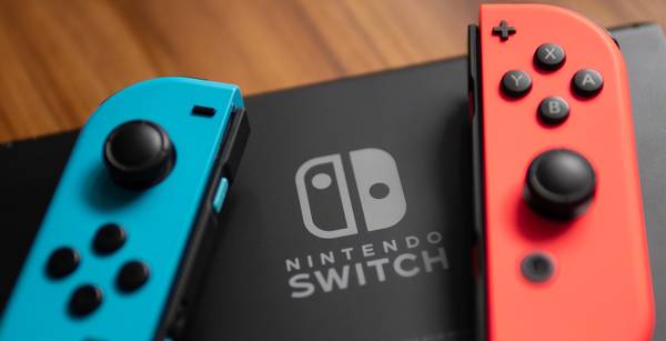 A close up photo a Switch logo on a Nintendo Switch.