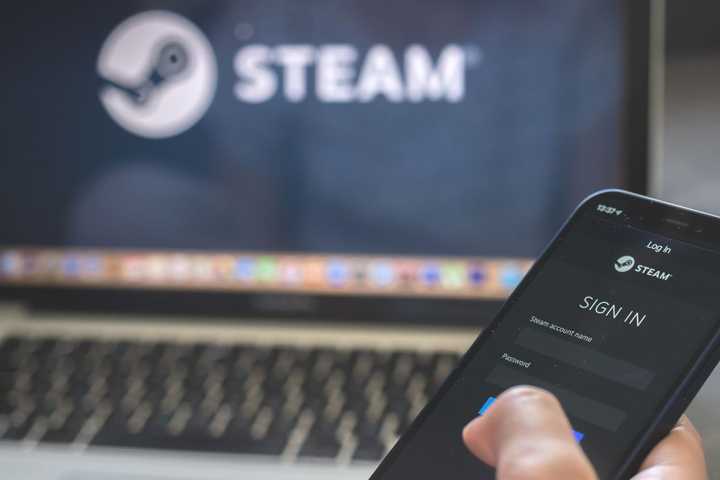 Woman using smartphone with steam app