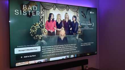 Colored lights behind a Smart TV with Apple TV open