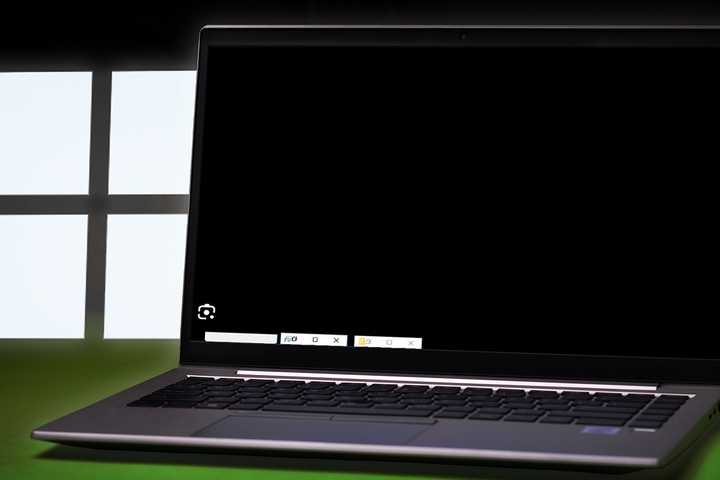 A laptop showing a blackscreen with the Windows logo on the side