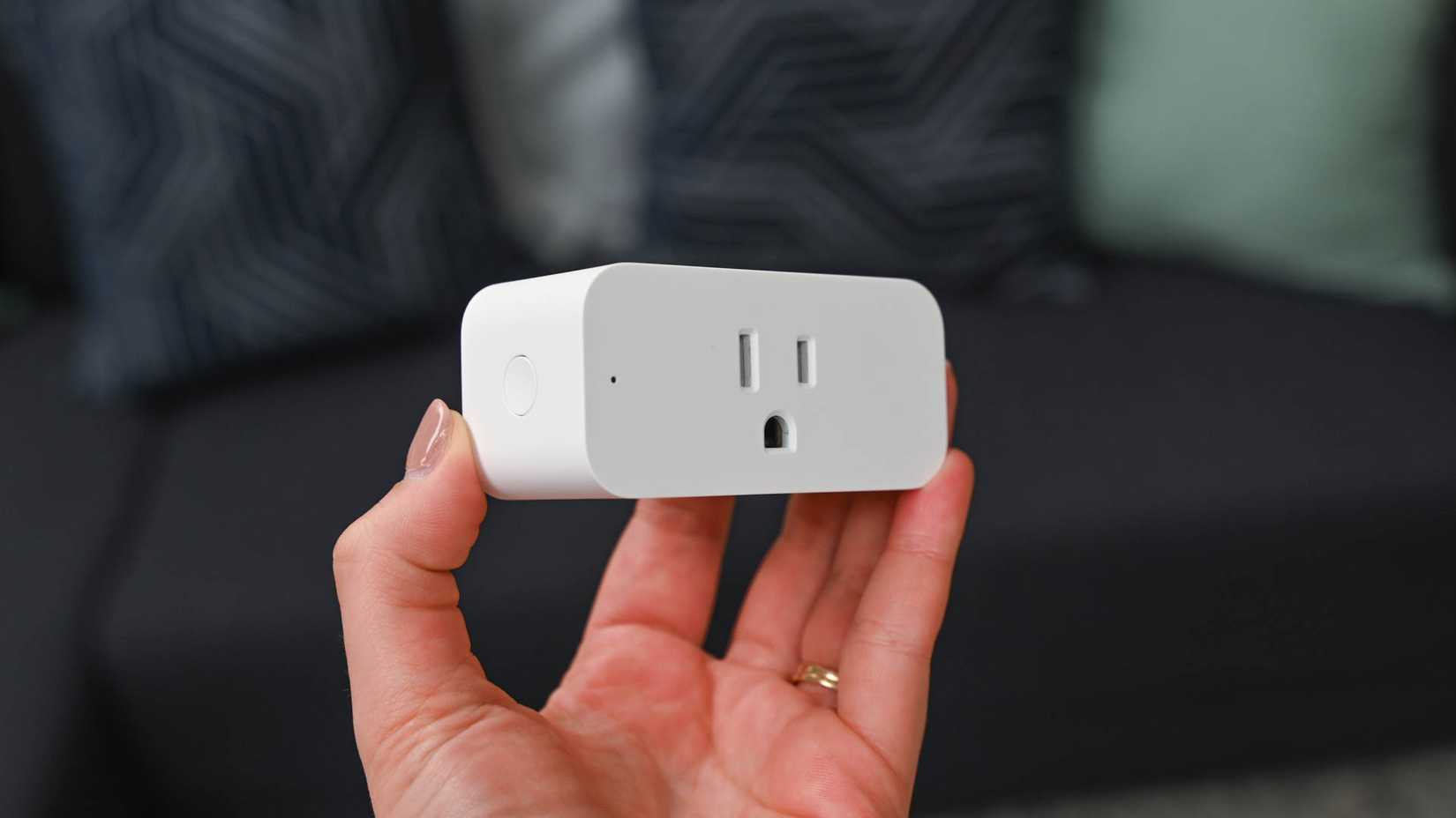 Person holding an Amazon Smart Plug.