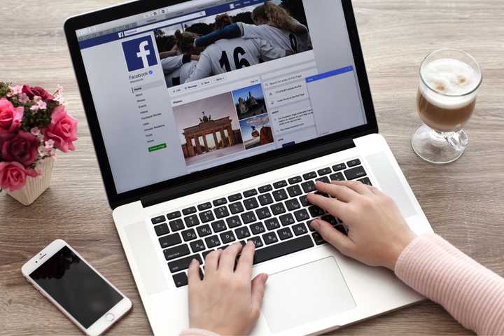 a person using facebook on a laptop