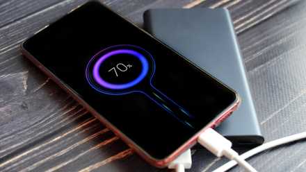 a power bank charging an Android phone