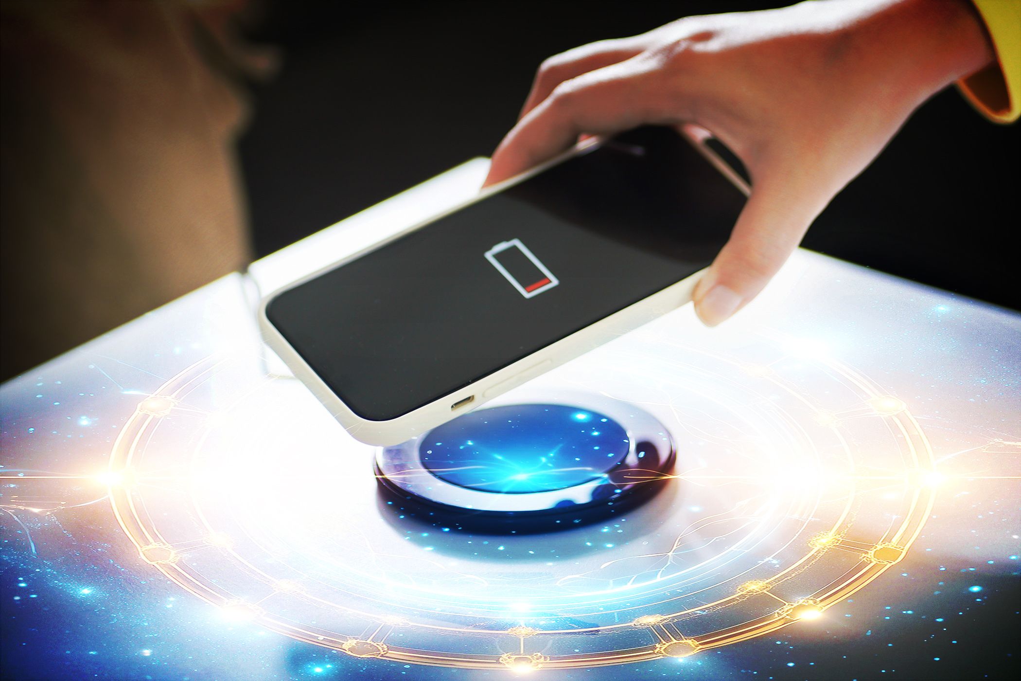 person touching smartphone to wireless charging point