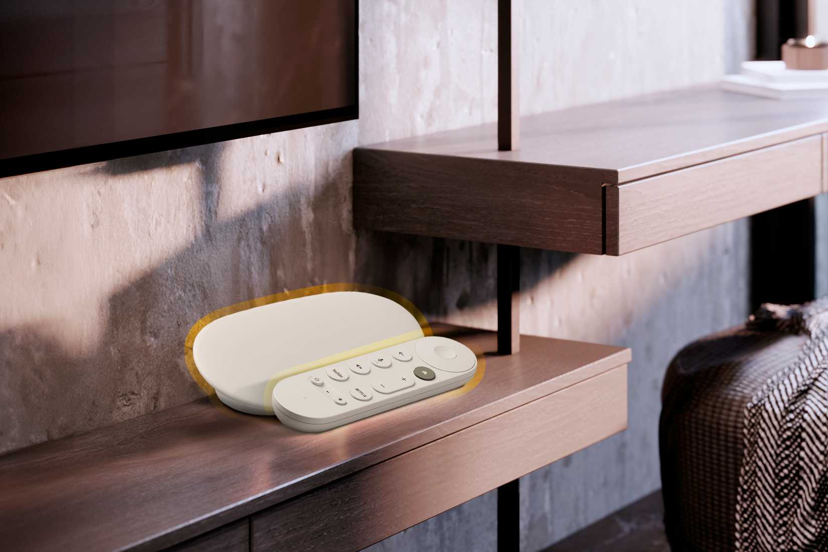 A Google TV Streamer on a TV stand.
