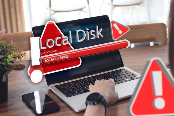 A laptop with a warning indicating that the local disk is full.