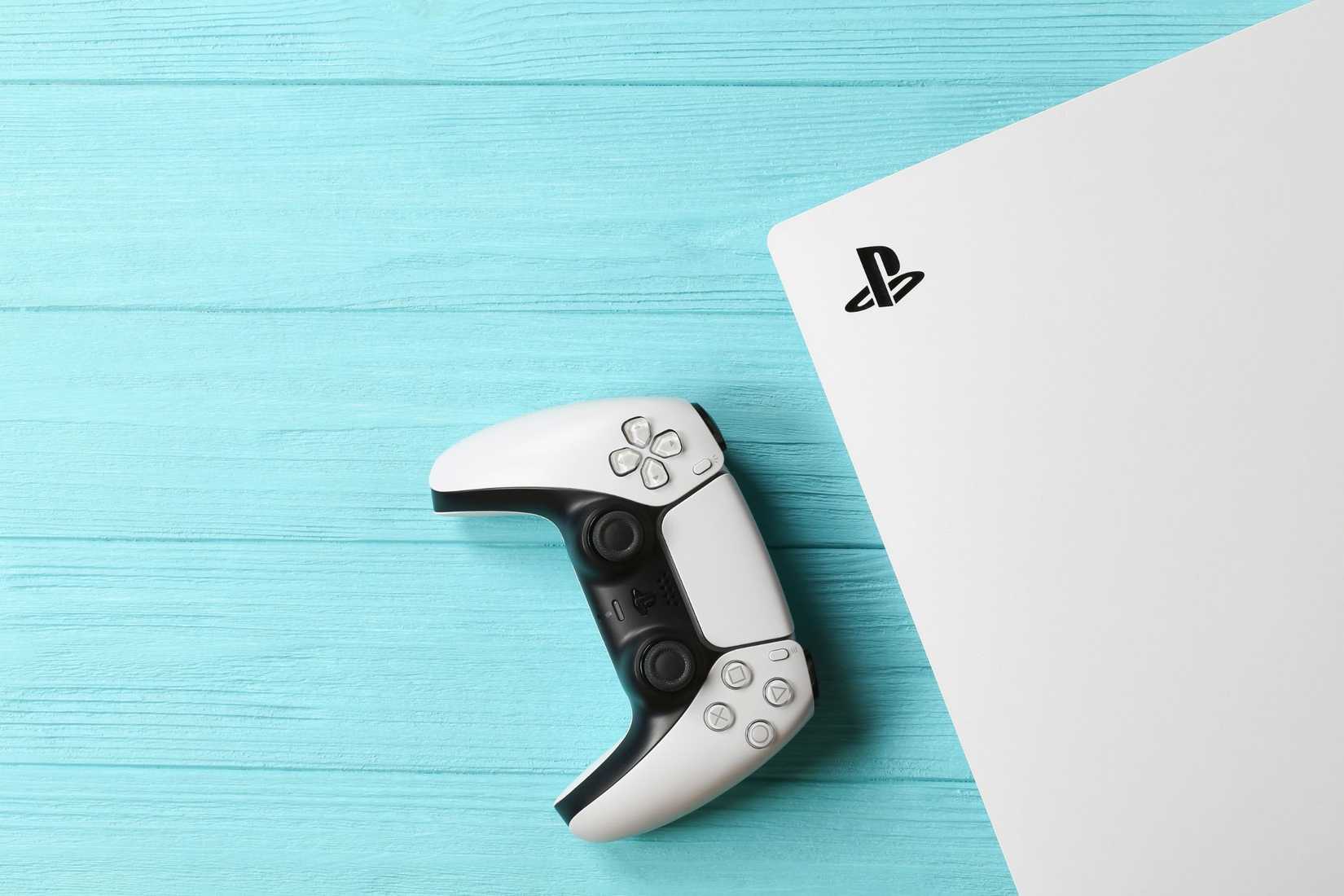 a ps5 controller and console on a blue background