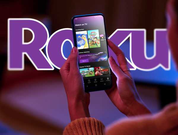 A woman with the Roku app on her smartphone and the Roku logo in the background.