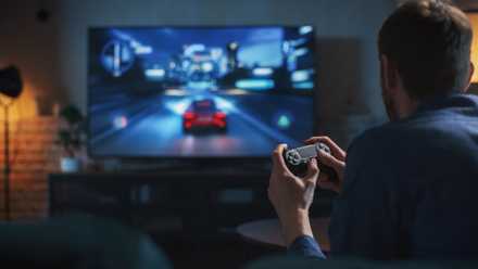 a man playing games on his tv