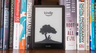 amazon kindle on bookshelf with real books