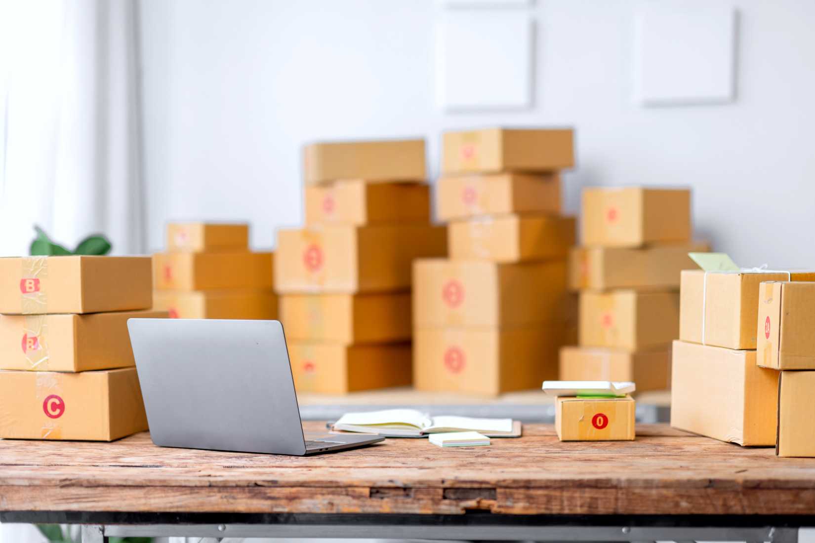 packages in a room with laptop on table