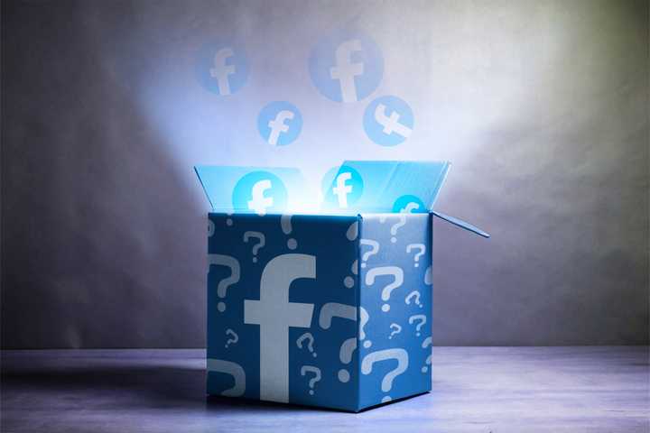 A mystery box with the Facebook logo, several question marks, and light coming out of the box.