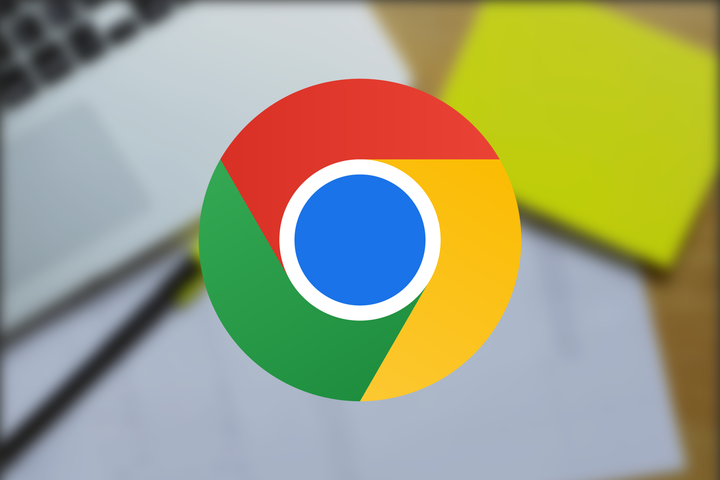 Google Chrome logo in front of a desk with articles and a highlighter